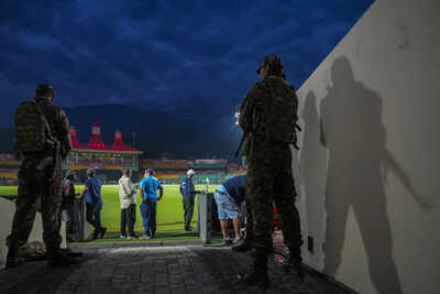 Dharamsala Security personnel stand guard amid a practice session ahead of an I